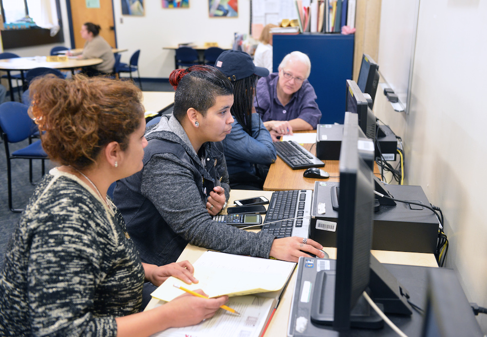 A student getting assistance with using a computer